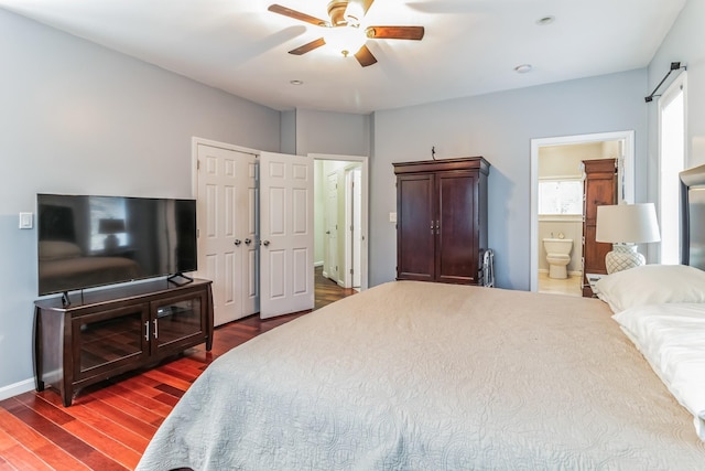 bedroom with ceiling fan, dark wood-type flooring, and ensuite bathroom