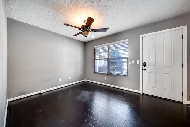 foyer entrance featuring ceiling fan, a textured ceiling, and dark hardwood / wood-style flooring