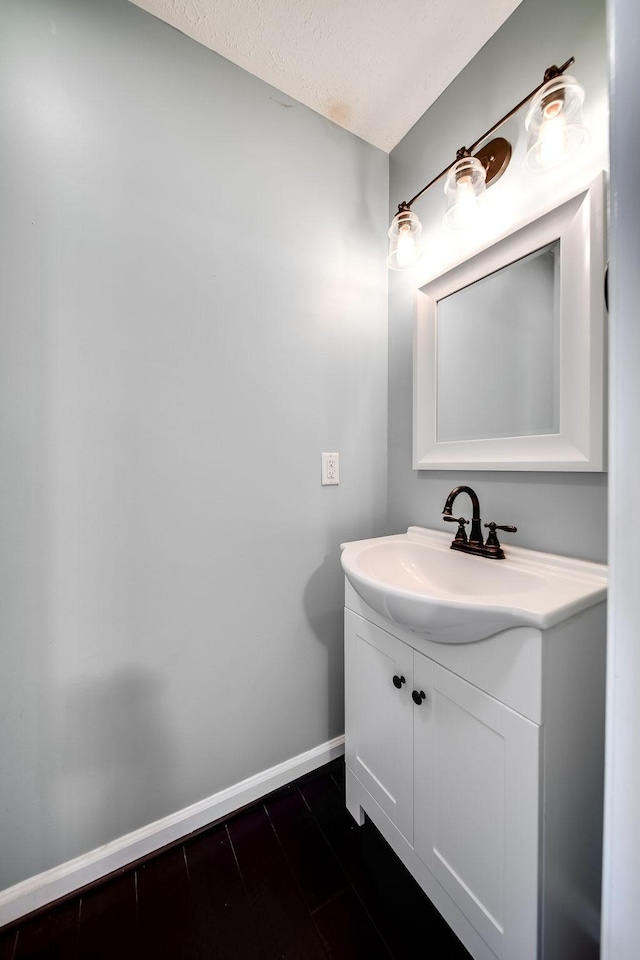 bathroom with a textured ceiling and vanity