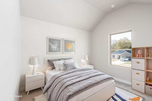 bedroom with light colored carpet and vaulted ceiling