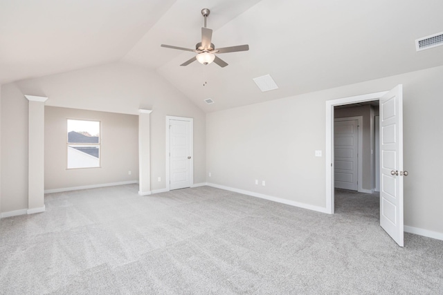 interior space with ceiling fan, vaulted ceiling, and light carpet