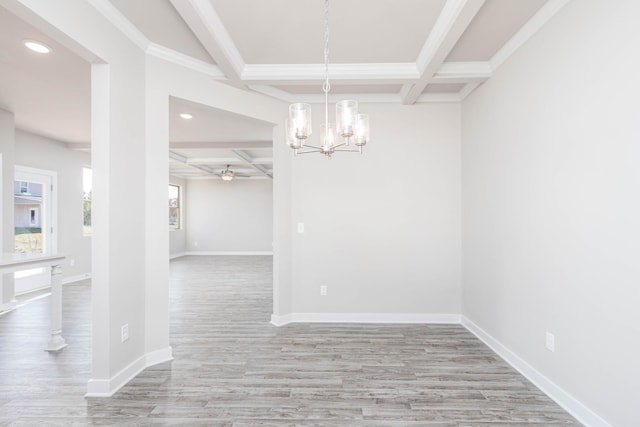 unfurnished dining area featuring ceiling fan with notable chandelier, beamed ceiling, light hardwood / wood-style floors, crown molding, and coffered ceiling