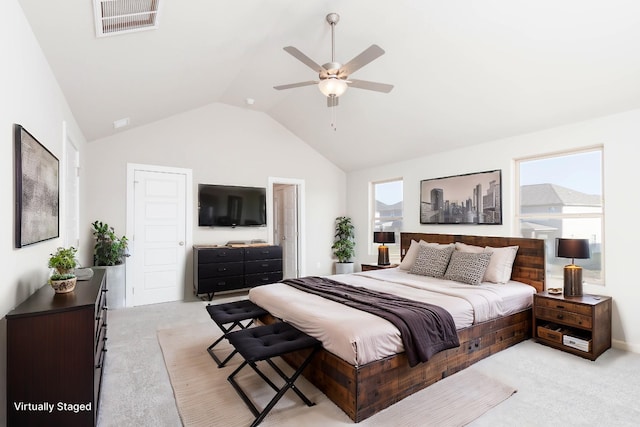 bedroom featuring ceiling fan, light colored carpet, and multiple windows