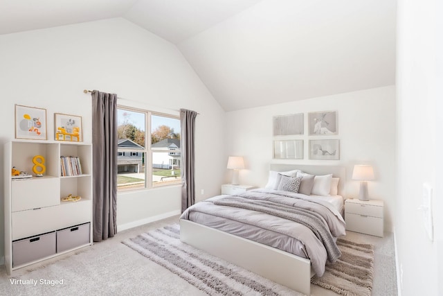 bedroom with light carpet and lofted ceiling