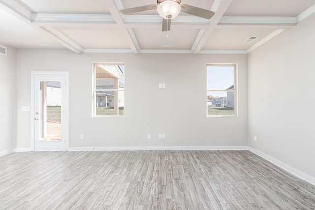 spare room featuring coffered ceiling, a healthy amount of sunlight, and light hardwood / wood-style flooring