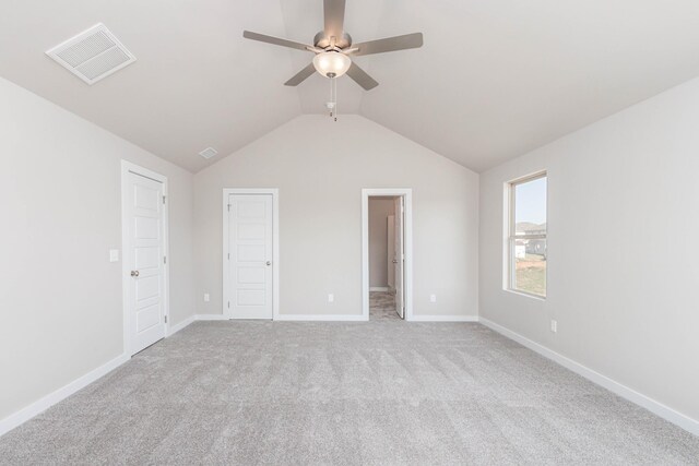 unfurnished bedroom featuring ceiling fan, light colored carpet, and vaulted ceiling