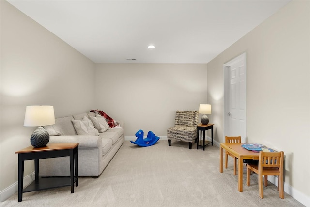 living area with light colored carpet