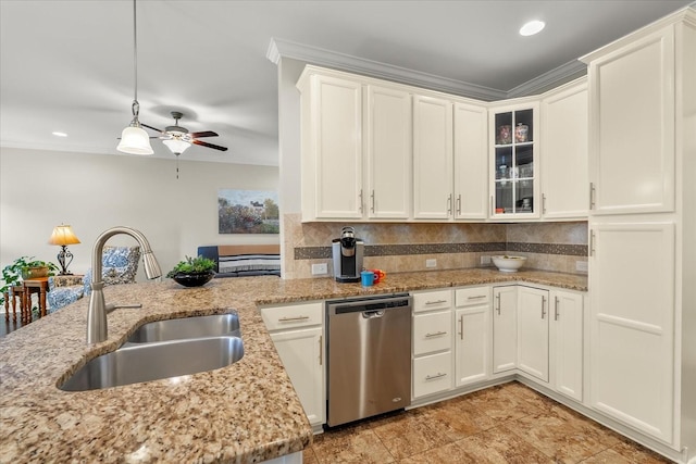 kitchen featuring pendant lighting, white cabinets, dishwasher, sink, and light stone counters