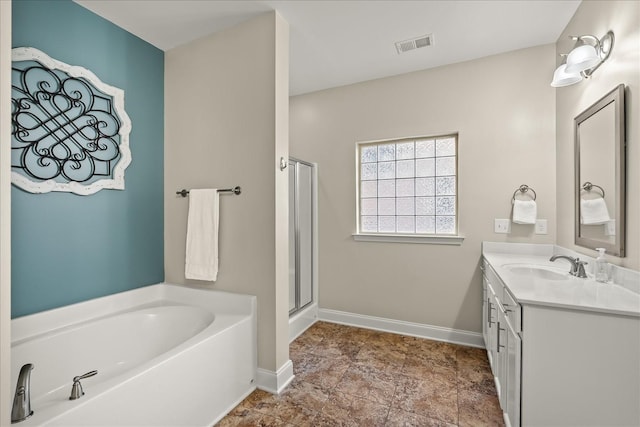 bathroom with a tub and vanity