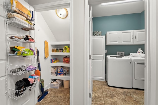 clothes washing area featuring independent washer and dryer and cabinets