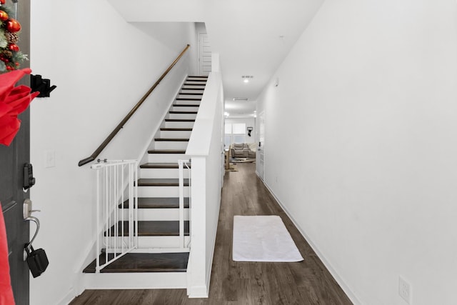 stairs featuring hardwood / wood-style floors