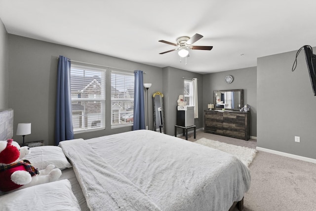 bedroom featuring light carpet and ceiling fan