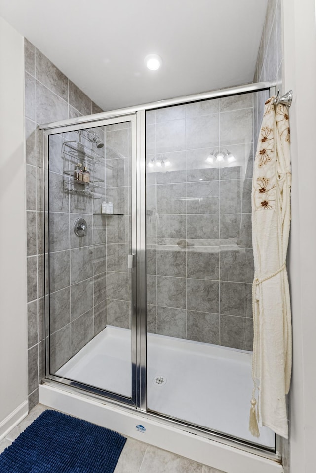 bathroom with walk in shower and tile patterned flooring