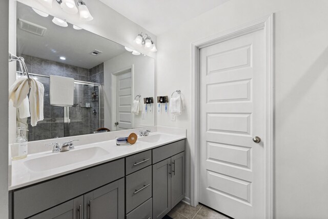 bathroom with tile patterned flooring, vanity, and an enclosed shower