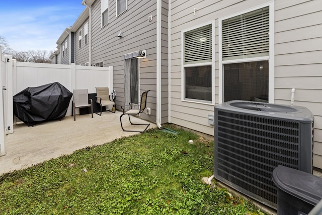 view of patio / terrace featuring cooling unit and a grill