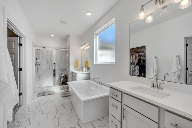 bathroom featuring vanity and shower with separate bathtub