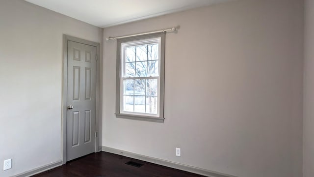 unfurnished room featuring dark wood-type flooring