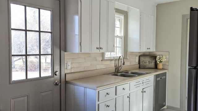 kitchen with sink, tasteful backsplash, white cabinetry, and appliances with stainless steel finishes