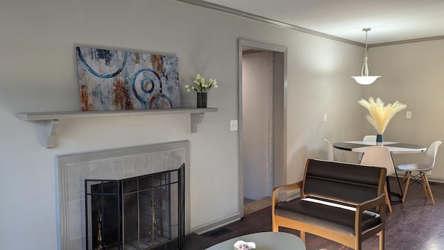 living room with crown molding and dark hardwood / wood-style flooring