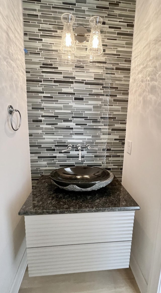 bathroom with vanity and tasteful backsplash