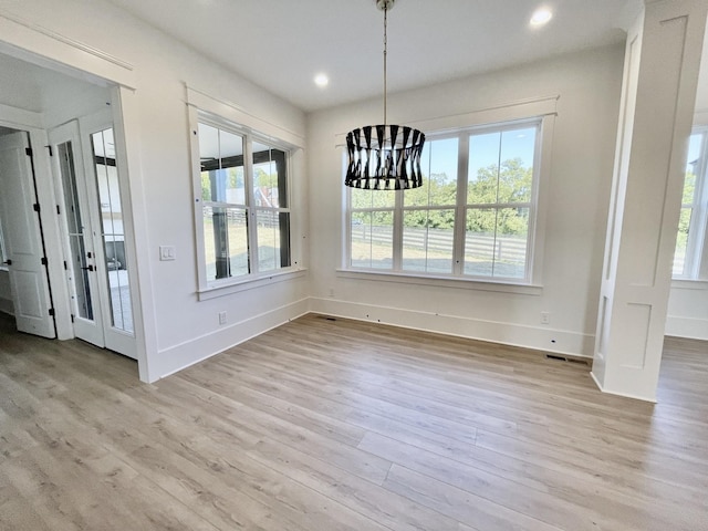 unfurnished dining area with light hardwood / wood-style floors