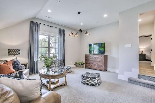 living room featuring light colored carpet and vaulted ceiling