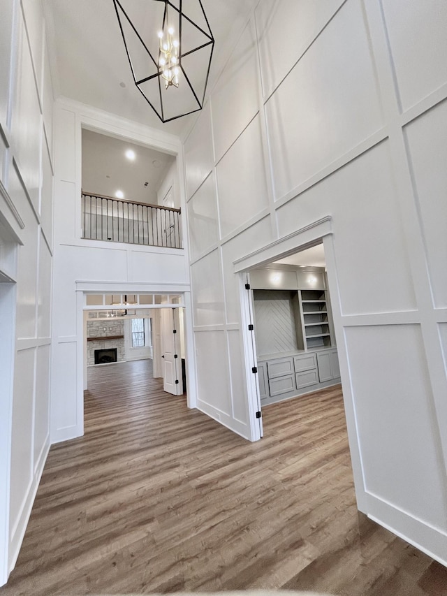 interior space with hardwood / wood-style flooring, a high ceiling, and an inviting chandelier