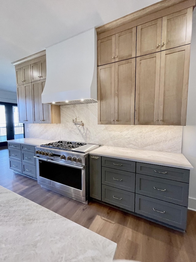 kitchen featuring decorative backsplash, high end stainless steel range, dark hardwood / wood-style flooring, and custom range hood