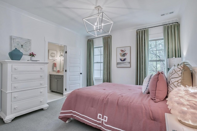 carpeted bedroom featuring crown molding, a chandelier, and ensuite bath