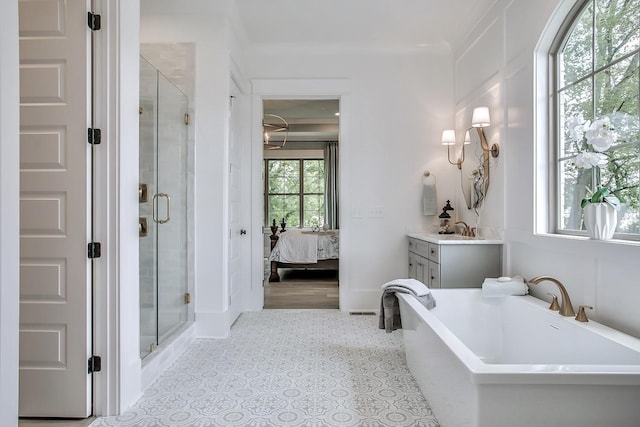 bathroom featuring ornamental molding, shower with separate bathtub, and vanity