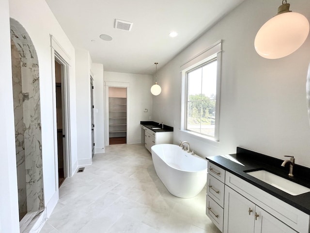 bathroom with vanity and shower with separate bathtub