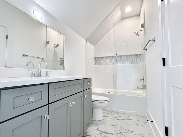 full bathroom featuring tiled shower / bath combo, vanity, and toilet