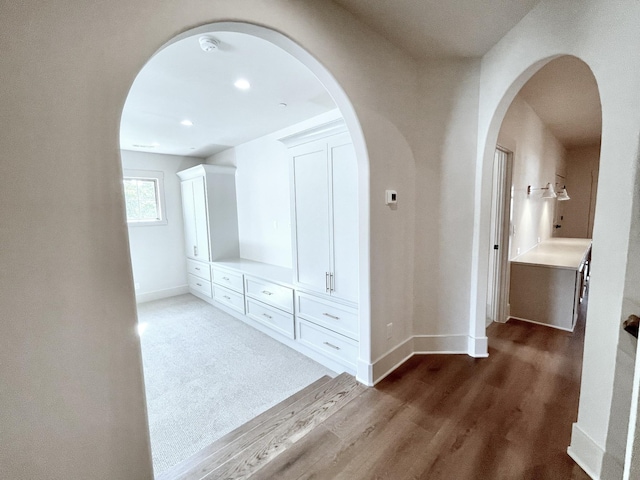 corridor with hardwood / wood-style flooring