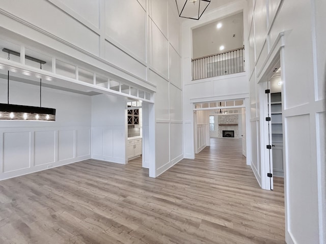 interior space featuring light hardwood / wood-style flooring and a towering ceiling