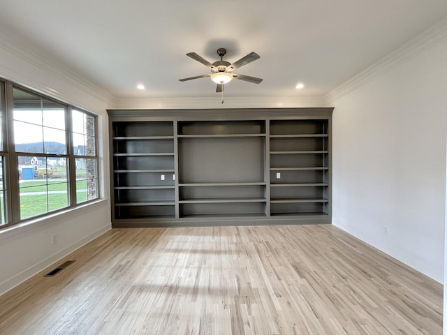 interior space with light hardwood / wood-style floors, ornamental molding, and ceiling fan