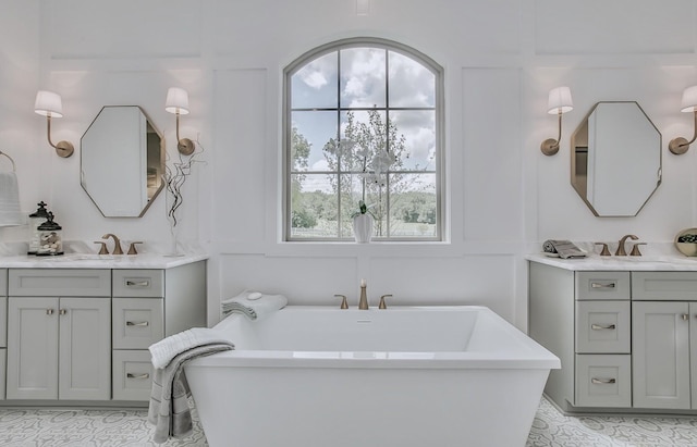 bathroom featuring plenty of natural light, a bathing tub, tile patterned floors, and vanity