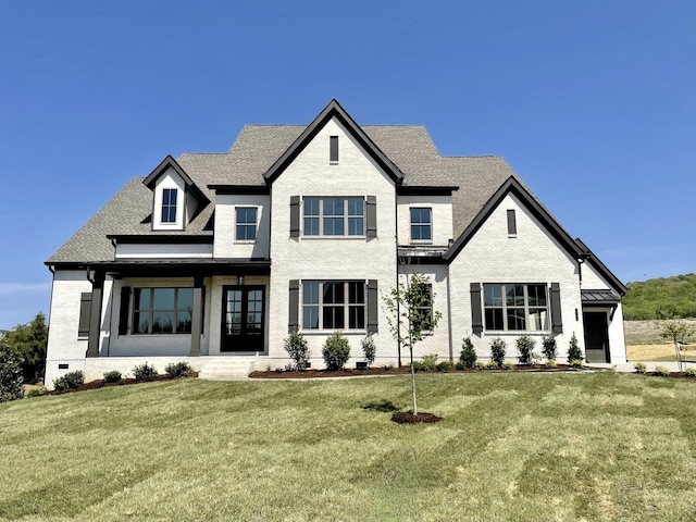 french country style house featuring a front yard