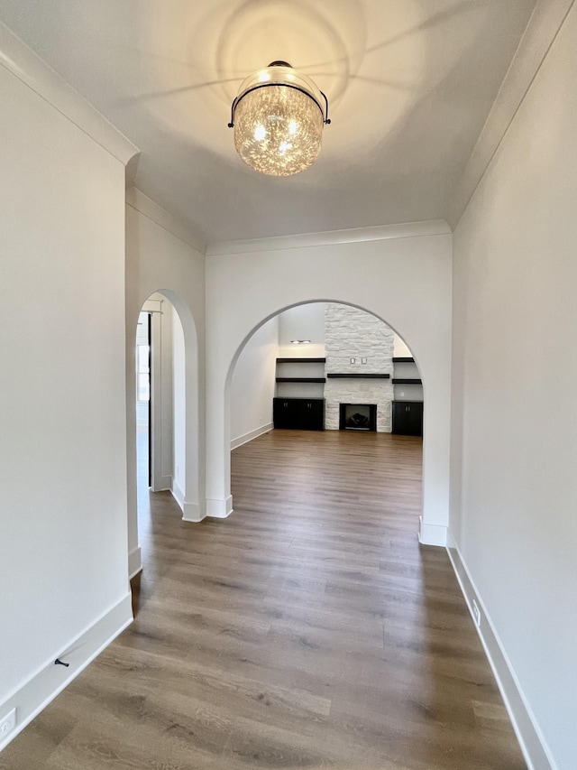 corridor featuring crown molding and hardwood / wood-style flooring