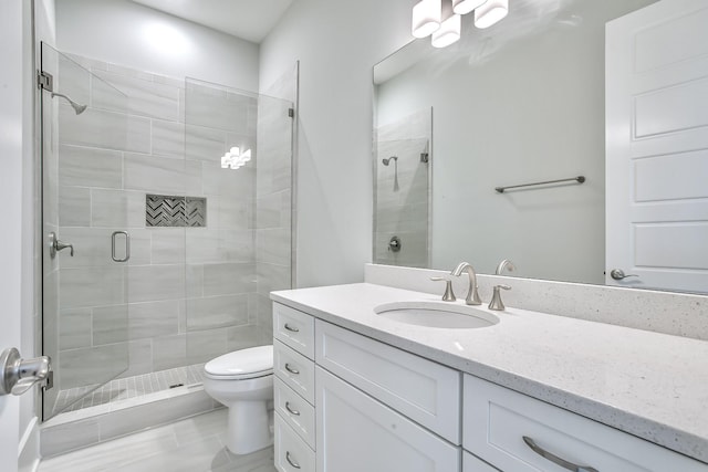 bathroom with walk in shower, vanity, and toilet