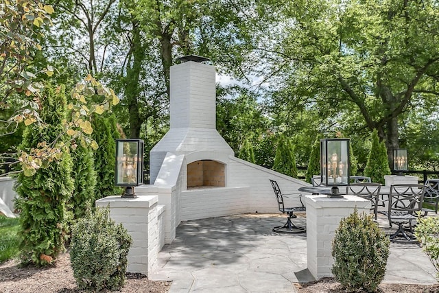 view of patio / terrace with an outdoor brick fireplace