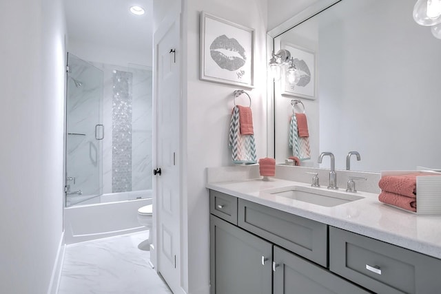 full bathroom with combined bath / shower with glass door, toilet, and vanity