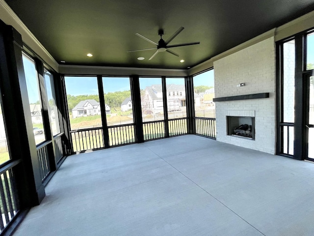 unfurnished sunroom featuring a brick fireplace