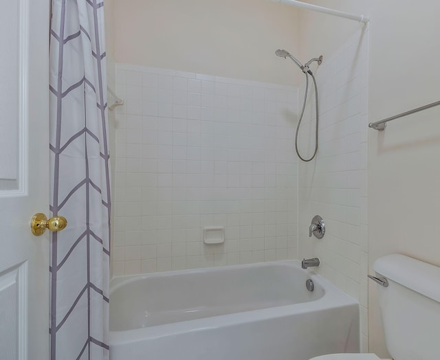 bathroom with shower / bath combo with shower curtain and toilet