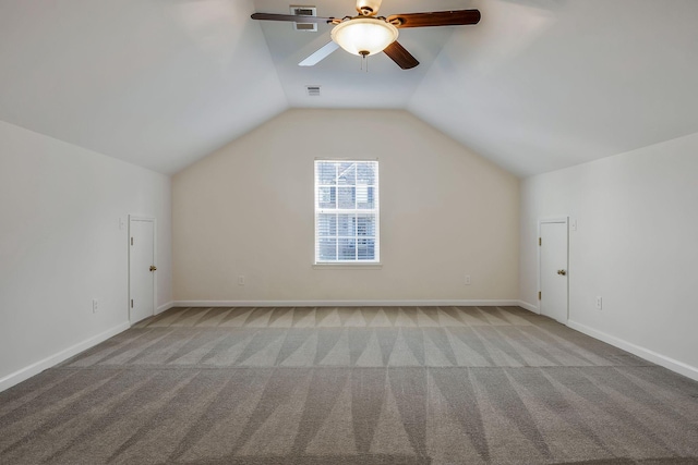 additional living space featuring ceiling fan, light colored carpet, and lofted ceiling