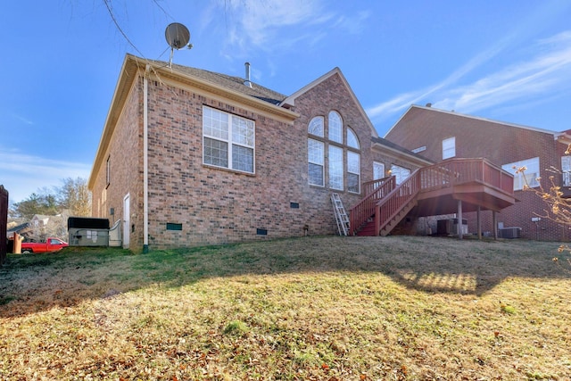 rear view of house featuring a deck and a lawn