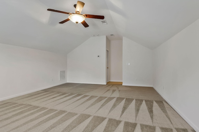 additional living space with ceiling fan, light colored carpet, and lofted ceiling