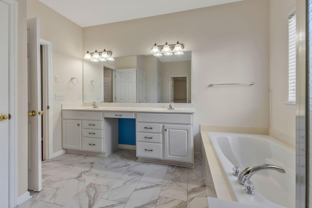 bathroom featuring tiled tub and vanity