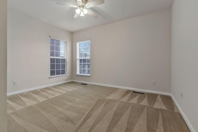 spare room with light carpet and ceiling fan