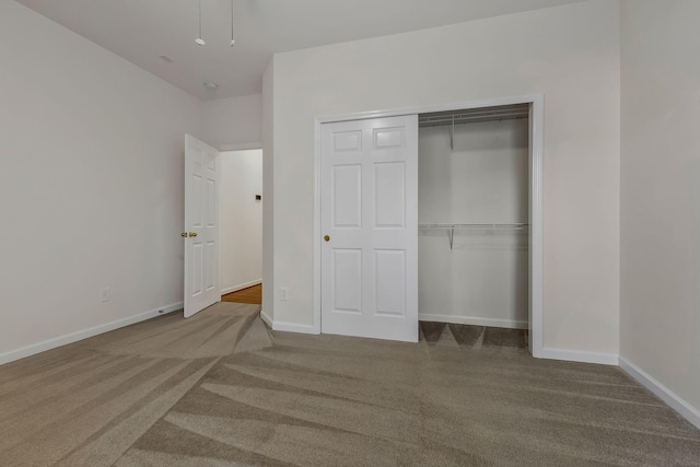 unfurnished bedroom with a closet and carpet floors