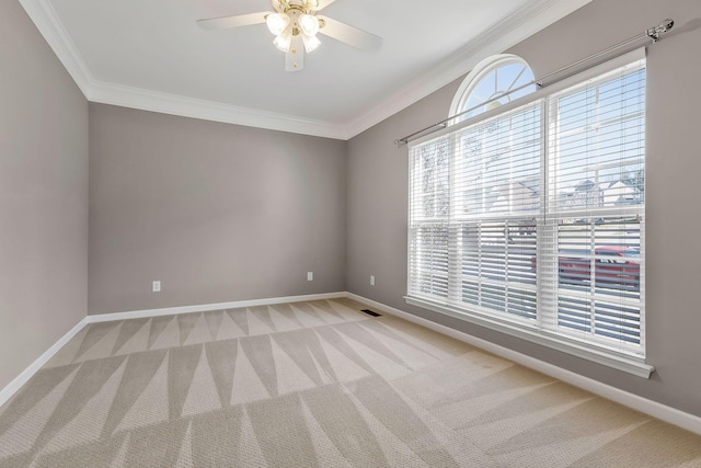 carpeted spare room featuring ceiling fan and ornamental molding